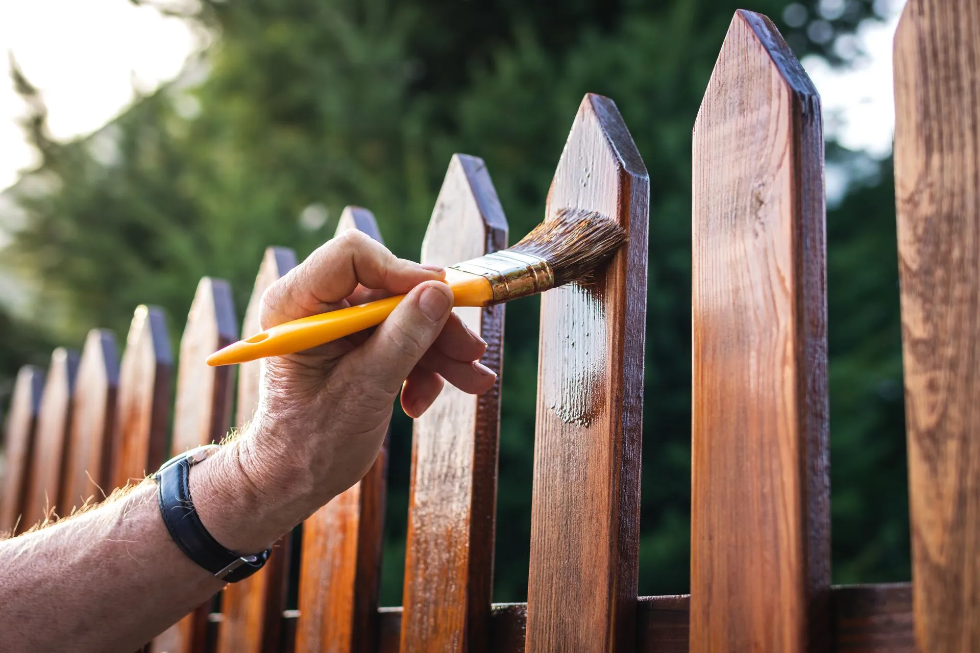 Fence painting process in London